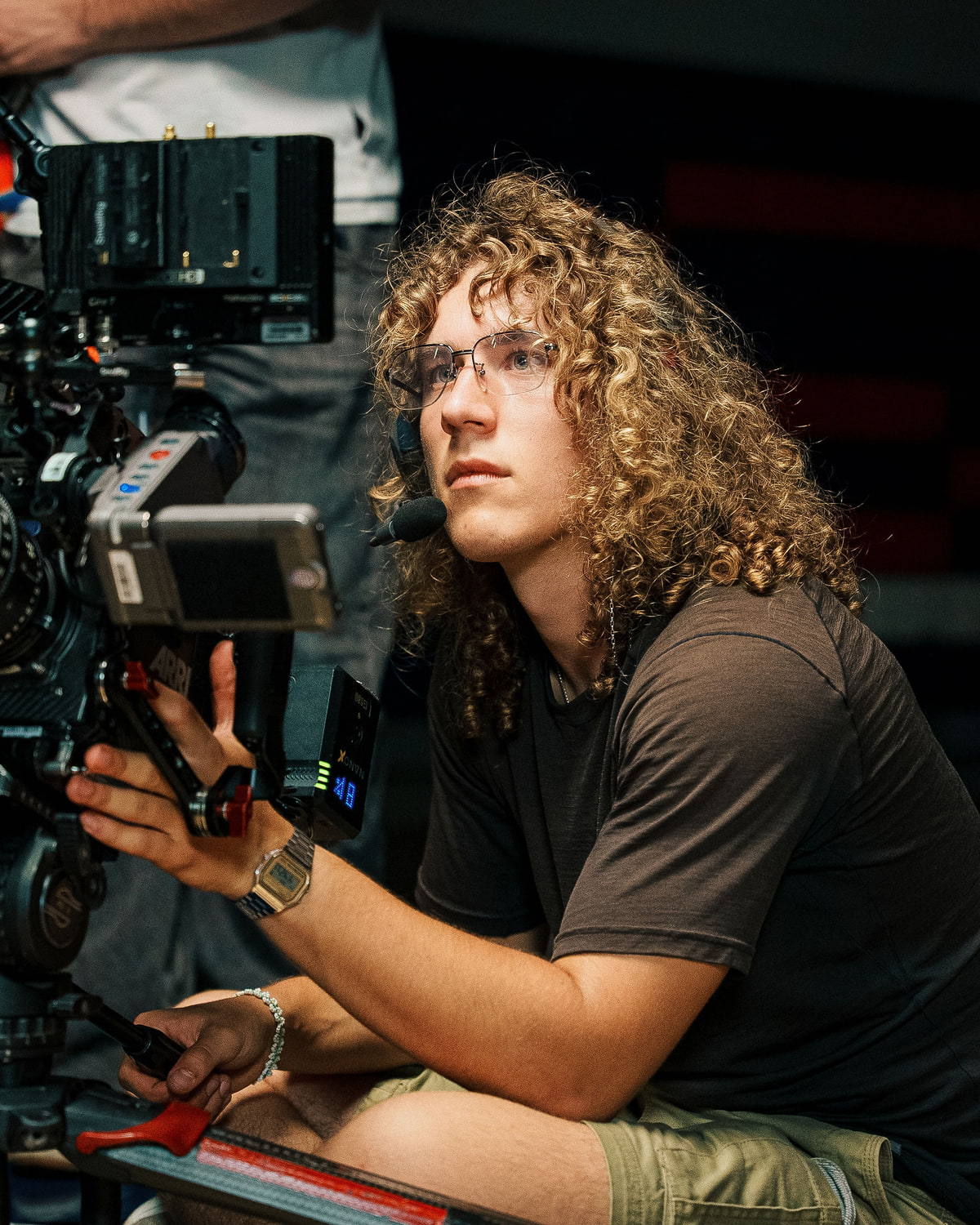 Cameron Keezer-Wulff operating a cinema camera on set