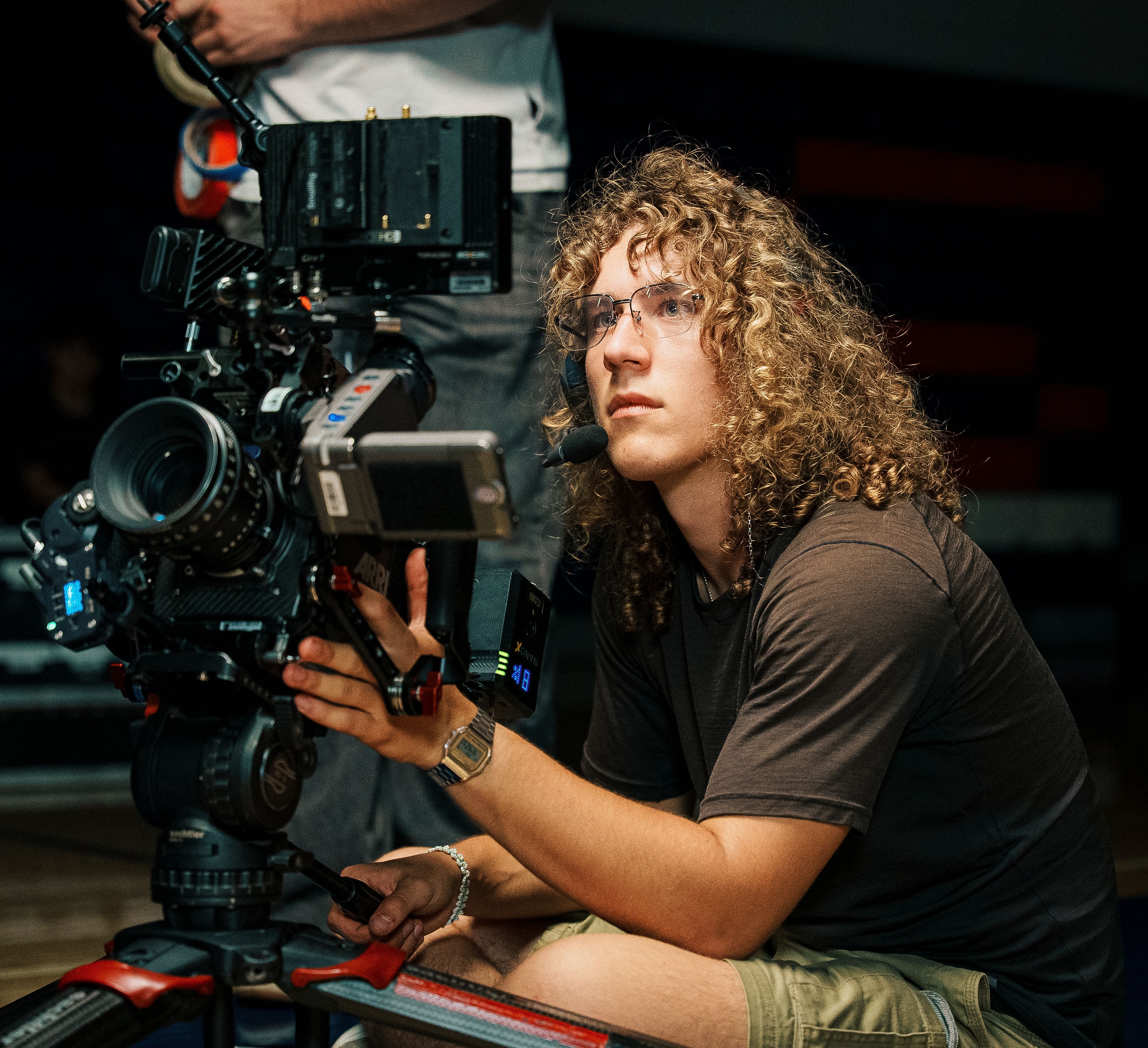Cameron Keezer-Wulff operating a cinema camera on set